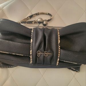 Small leather clutch sophisticated black purse with wristlet and brown accents